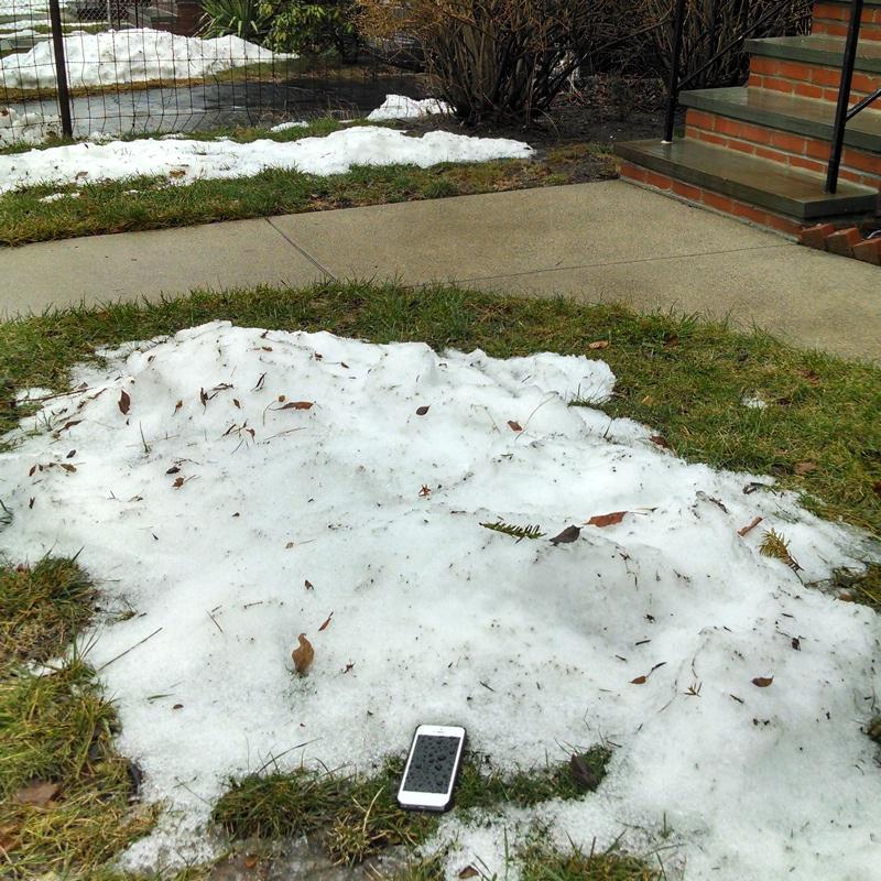 A phone appears in the snow